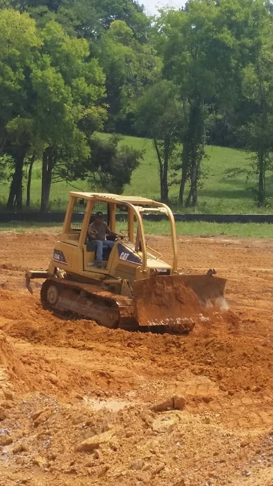 Our expert land grading service ensures a level, stable foundation for your landscaping projects, improving drainage and preventing erosion to enhance the beauty and functionality of your property. for Bodock Trucking Grading in Lebanon, TN