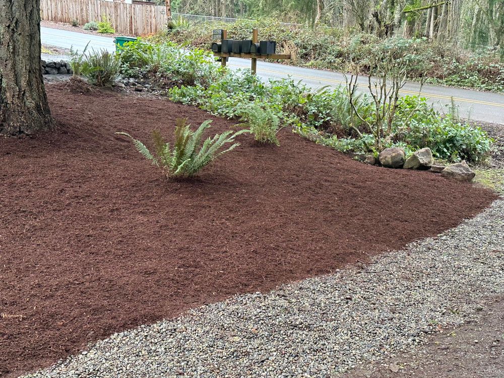Our Mulch Installation service provides homeowners with a cost-effective and efficient way to improve the appearance of their landscaping, retain moisture in the soil, and suppress weed growth. for Unique Landscaping in Poulsbo, WA