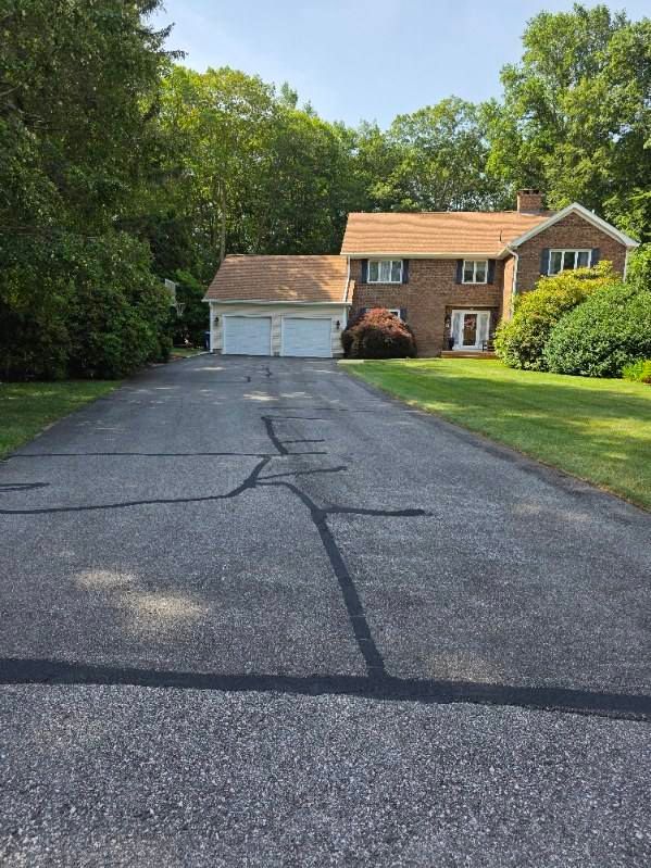 Our crack filling service seals pavement cracks before we spread, helping prevent water damage, extending asphalt life, and improving curb appeal with a smoother, safer surface for your home. for Royal Treatment Sealcoating in Seekonk, MA