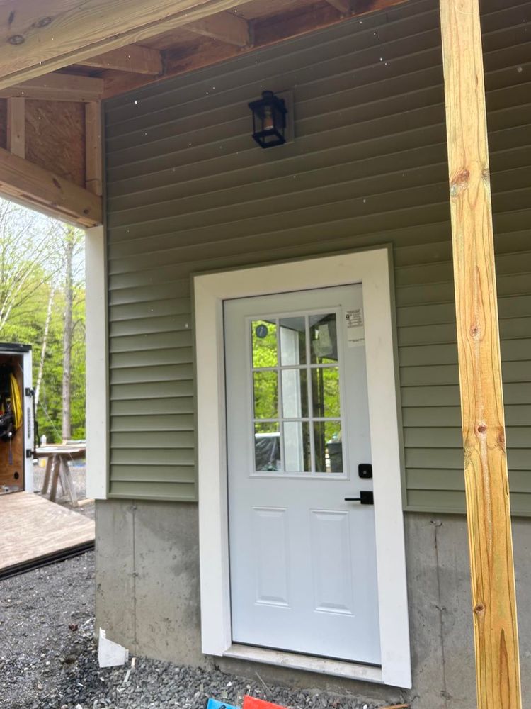 Enhance your home's aesthetic and durability with our expert vinyl siding house services. Our skilled team ensures precision installation, providing you with a low-maintenance, weather-resistant solution that boosts curb appeal and value. for Smith Enterprises in Chester, VT