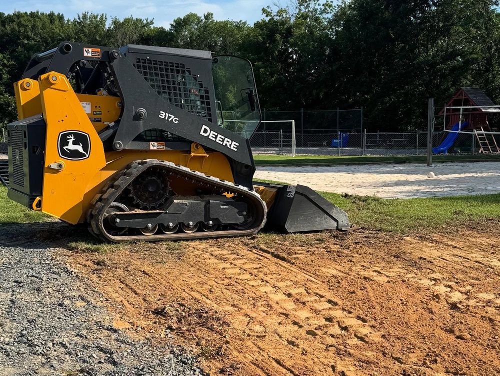 Our Skid Steer Work service efficiently tackles your landscaping needs, from grading to debris removal, ensuring a smooth and precise finish for your outdoor projects while saving you time and effort. for Grandview Lawn Care in Norwood, NC