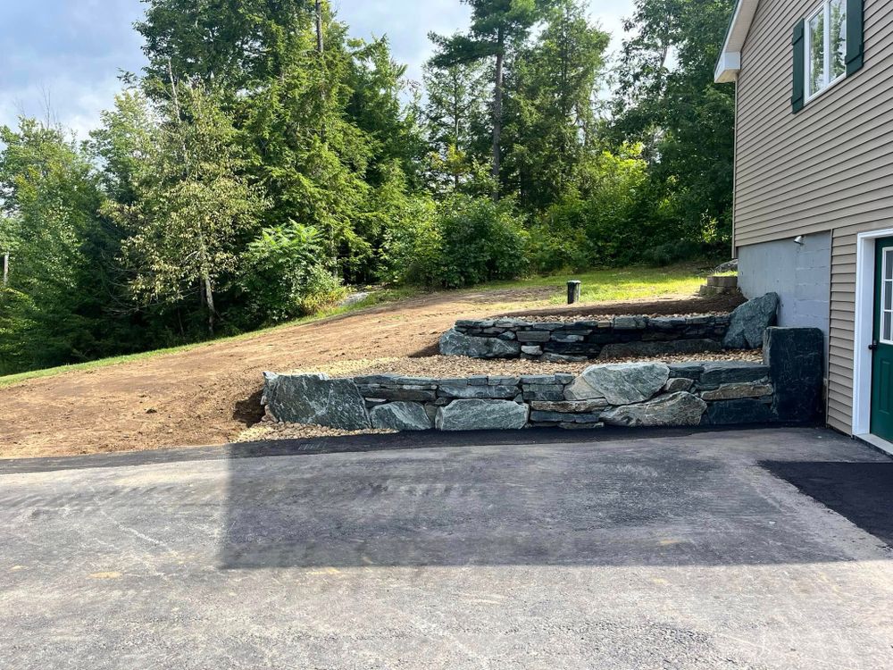 Our Retaining Wall Construction service offers durable, aesthetically pleasing solutions to prevent soil erosion and manage landscape elevation changes, enhancing your property's stability and appearance with expert craftsmanship tailored to your needs. for JKT Contracting in Keene, NH