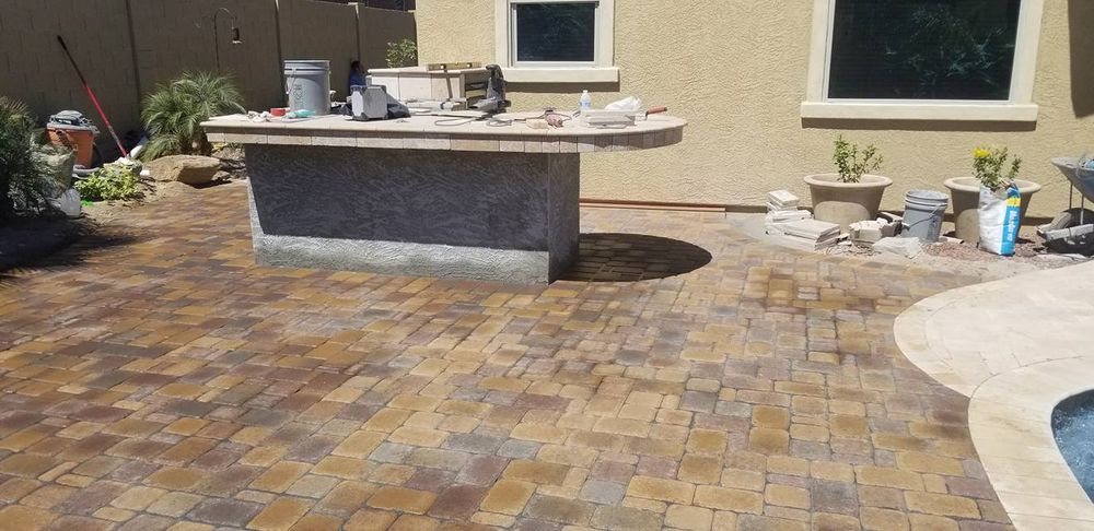 Enhance your backyard with our expert outdoor kitchen construction service, seamlessly integrating it into your existing space through exceptional patio design & construction for a functional and stylish entertaining area. for Kanelo's Hardscape and Landscape Services in Buckeye, AZ