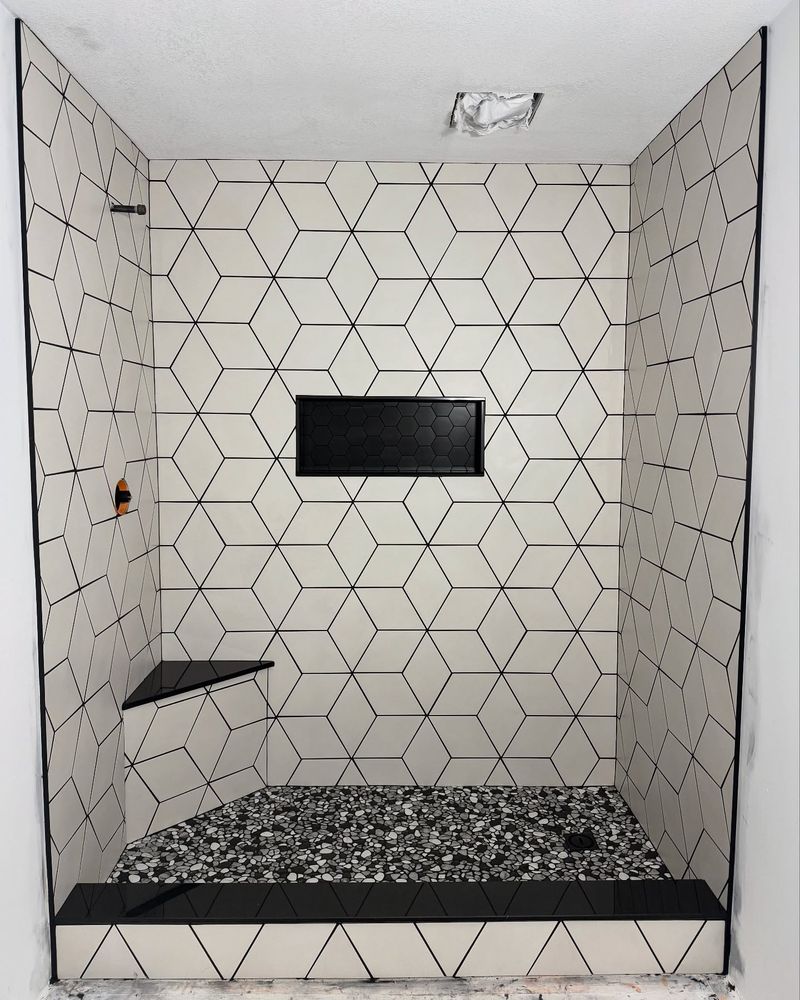 Transform your bathroom with our professional tiling installation. Our expert team ensures precise placement and high-quality materials for a stunning finish that enhances durability and elevates your space's aesthetic appeal. for Artistry in Tile LLC in Rochester, MN