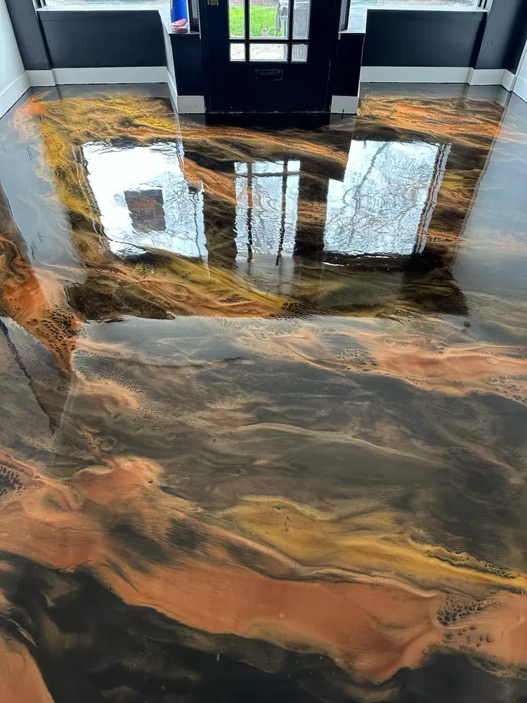 Enhance your home's aesthetic with our Metallic Epoxy service—transformative flooring that combines durability with a stunning shimmer finish to create uniquely beautiful and long-lasting surfaces in any room. for Fade Out Lines, LLC in Chapin, SC