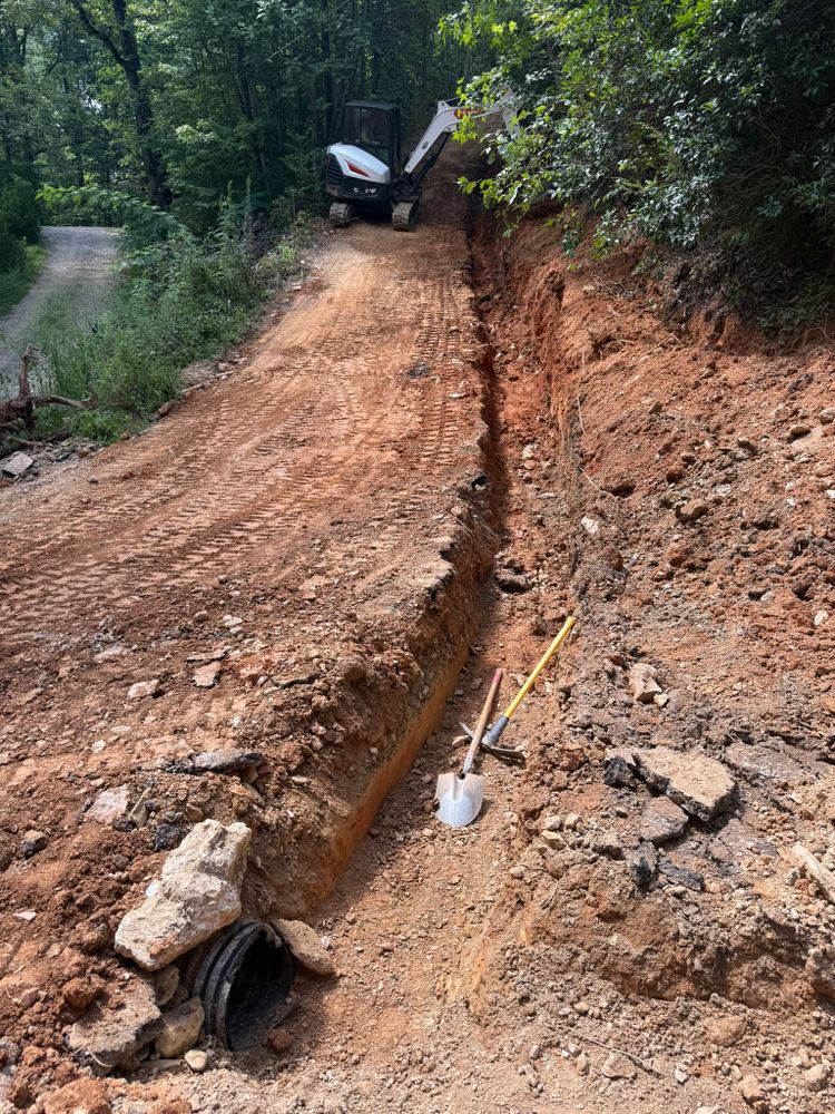 Our Ditches service efficiently creates and maintains drainage ditches to effectively manage water runoff, preventing soil erosion and protecting your property from potential flooding. Trust our experts for reliable and quality solutions. for Dutch Mountain Excavating in Sevierville, TN