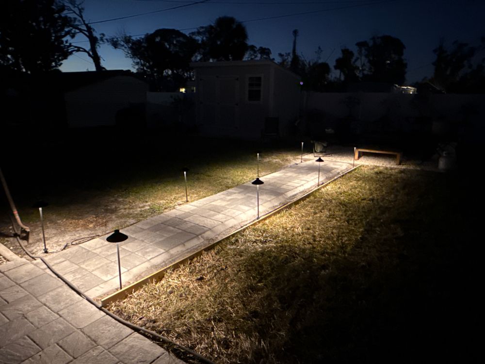 Enhance your home's beauty and safety with our professional landscape lighting service. We specialize in landscape and design, illuminating pathways, gardens, and trees to create a stunning outdoor ambiance. for MX Trees LLC in Englewood, FL