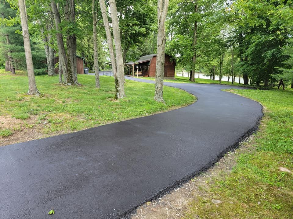 Enhance your home's curb appeal with our expert roadway paving services, offering durable, smooth asphalt solutions customized to withstand wear and weather while providing a safe driving surface for years to come. for Smith's Paving and Sealcoating in Rushville, IN