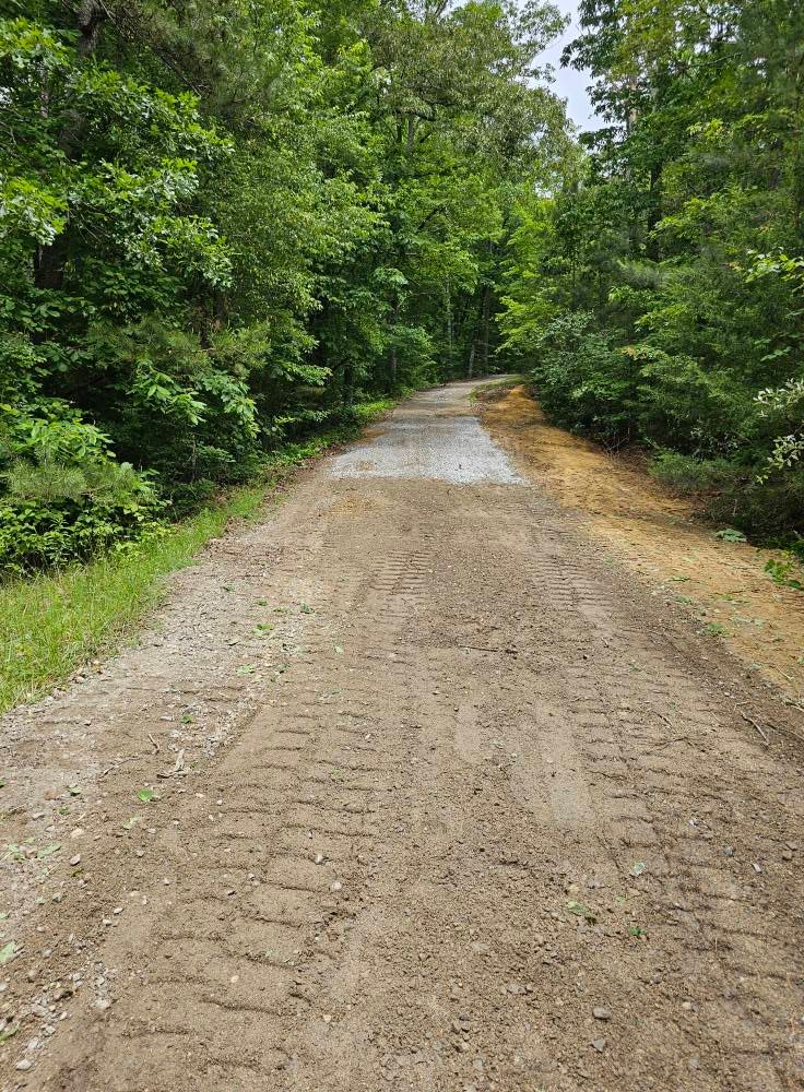 Our Roadbeds service ensures a stable, durable foundation for your driveways and pathways, utilizing expert excavation techniques to enhance safety and longevity while seamlessly integrating with your property's landscaping design. for Whaley Land Development in Athens, TN