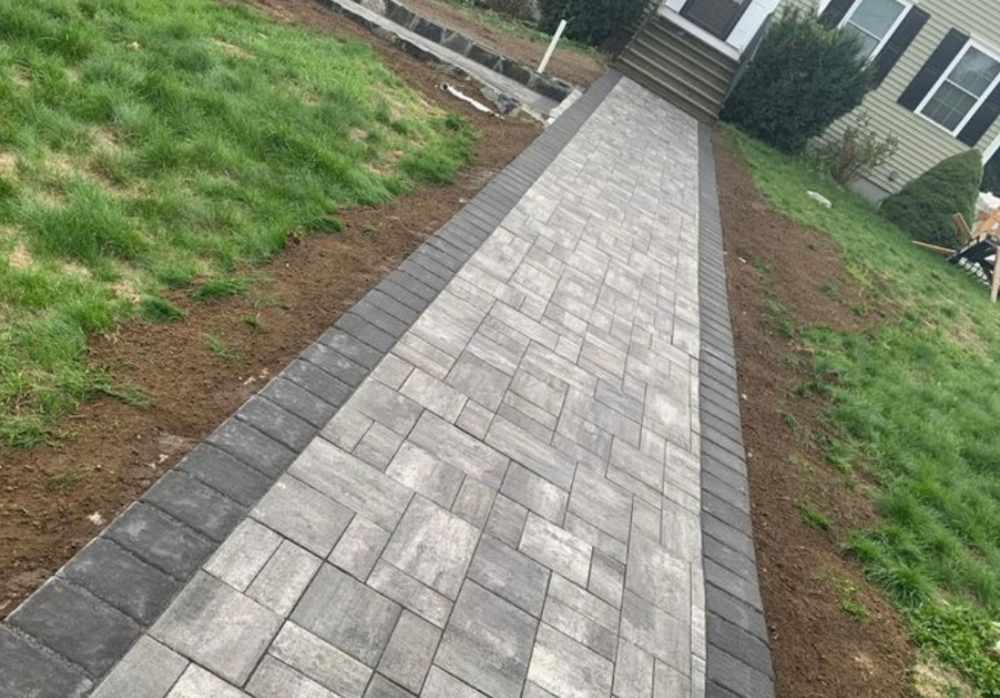 Our Pavers and Walkways service offers professional masonry craftsmanship to enhance your home's outdoor space with beautifully designed, durable pathways and driveways. for Select Masonry & Roofing in Framingham, MA