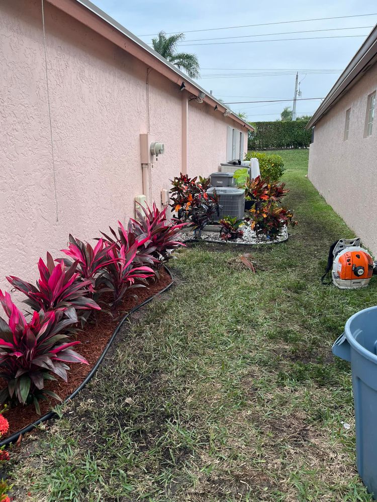 Our Mulch Installation service provides homeowners with professional assistance in spreading mulch onto their outdoor spaces, enhancing the aesthetics and promoting healthier plant growth. for Green Earth Landscaping & Lawn Care in West Palm Beach,  FL