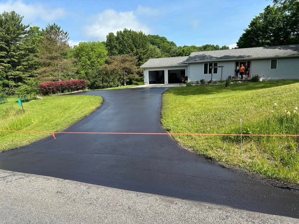 Enhance your driveway's durability with our seal coating service, providing a protective layer against weather damage, UV rays, and cracking. experience extended pavement life while maintaining a smooth and attractive finish. for Buddy’s Blacktop in Cadillac, MI