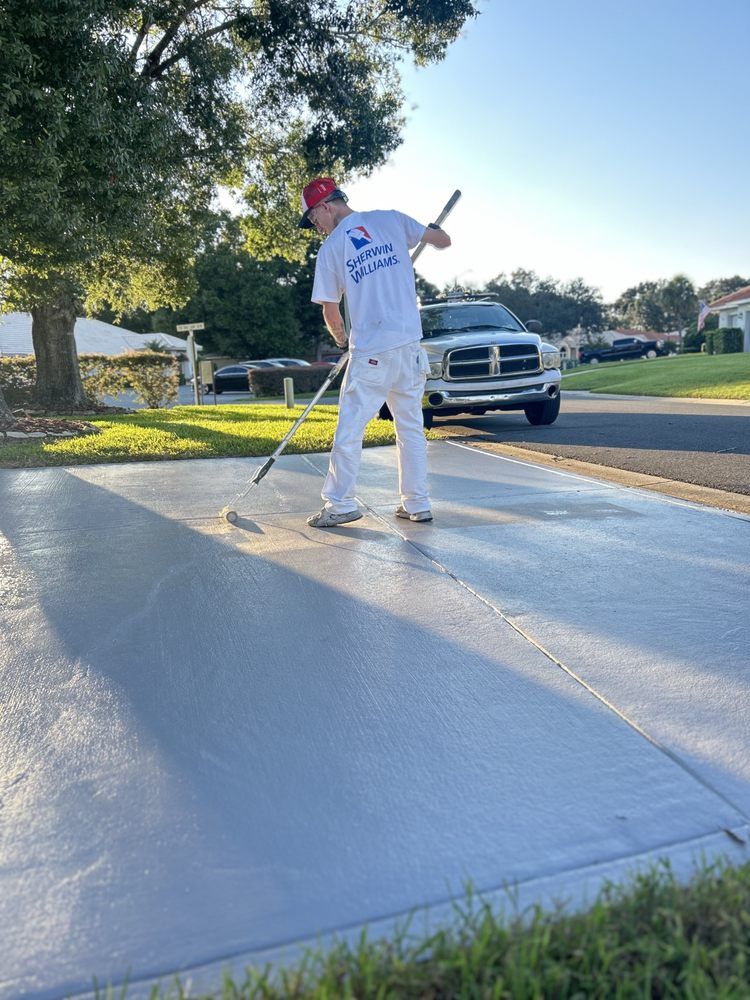 Our Concrete Floor Coatings offers homeowners a professional solution to enhance and refresh the appearance of their driveway and garage, adding curb appeal to their property. for Vivid Paint Solutions, LLC. in Eagle Lake, FL