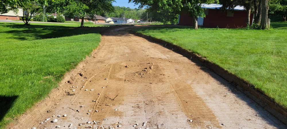 Our Land Grading service expertly reshapes your outdoor spaces, removing obstacles like tree stumps to ensure a smooth and even surface, while enhancing drainage and preparing the area for landscaping projects. for Admiring Landscapes in Lancaster, OH