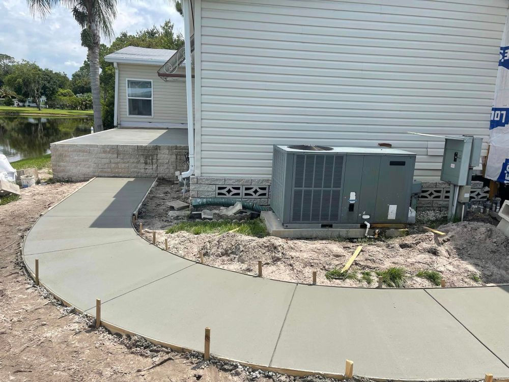 Transform your outdoor space with our Sidewalk Installation service. Our experienced team will create a durable and visually appealing sidewalk that enhances the beauty and functionality of your home. for Florida Universal Concrete in Lakeland, FL