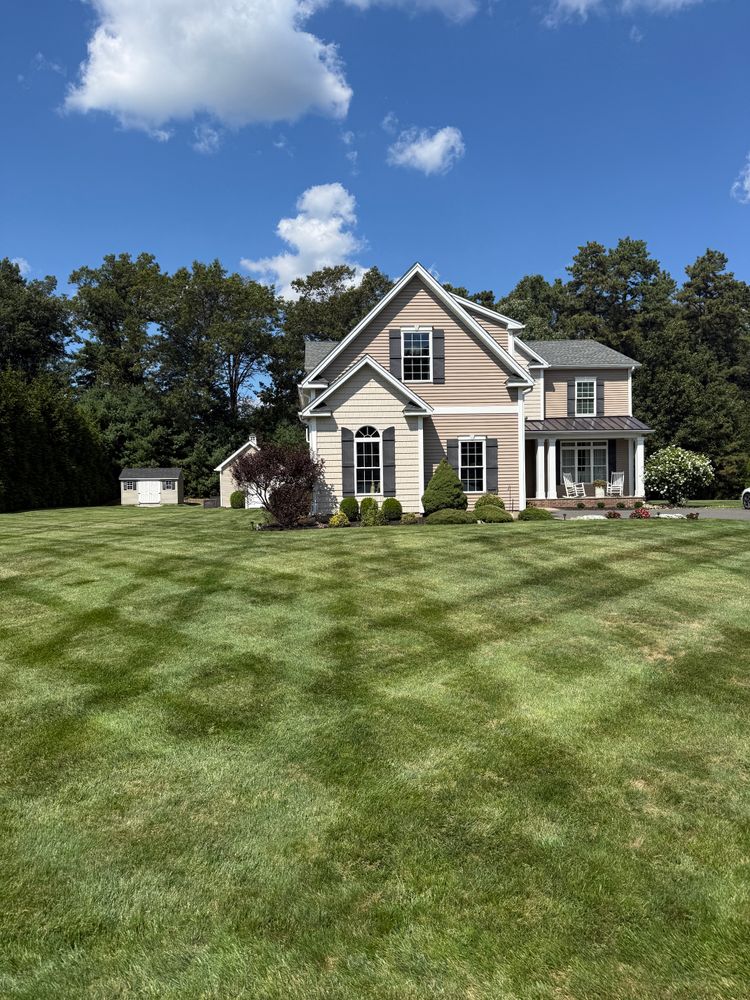 Our expert mowing service ensures a perfectly manicured lawn, enhancing your home's curb appeal with precision cuts and tailored care designed to promote healthy grass growth and vibrant greenery all year round. for Blades of Glory LLC in Cheshire, CT