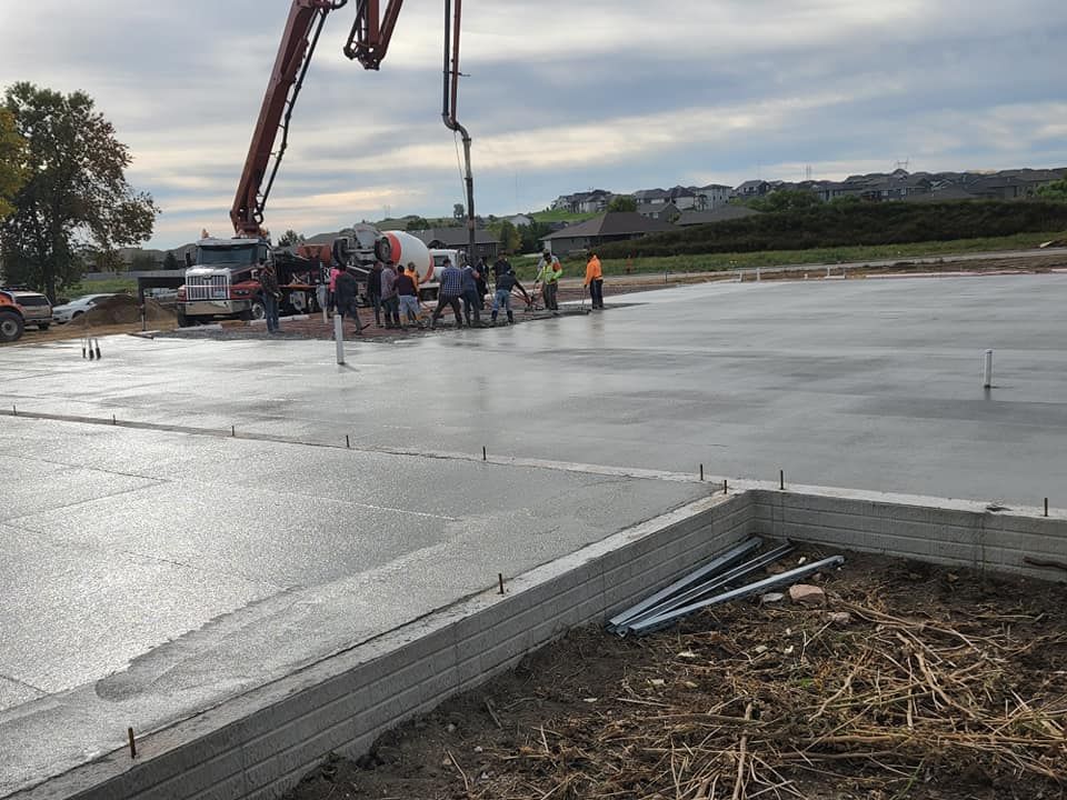 Our Concrete Pours service involves expertly placing and leveling concrete to create durable foundations, driveways, or pathways for your home. experience the strength and versatility of what is concrete with us! for Travis Jasper Construction in Holland, MN