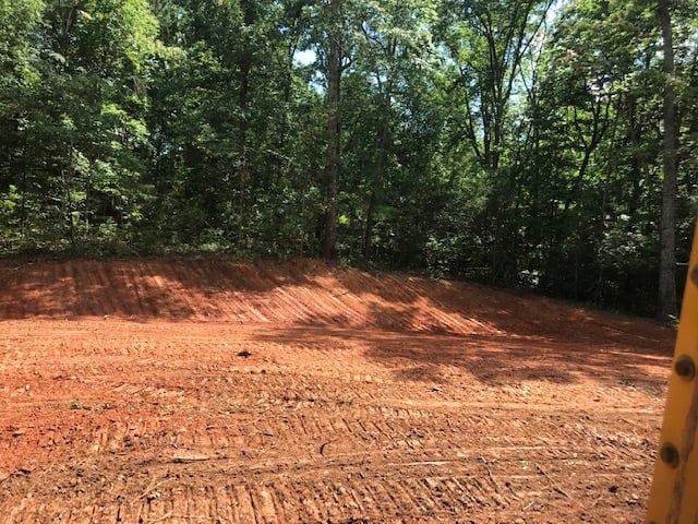 Our Land Grading service ensures a smooth, level surface for your property, improving drainage and preparing the area for construction while enhancing aesthetic appeal to increase your home's value and functionality. for Grading & Clearing Services in Dawsonville, GA