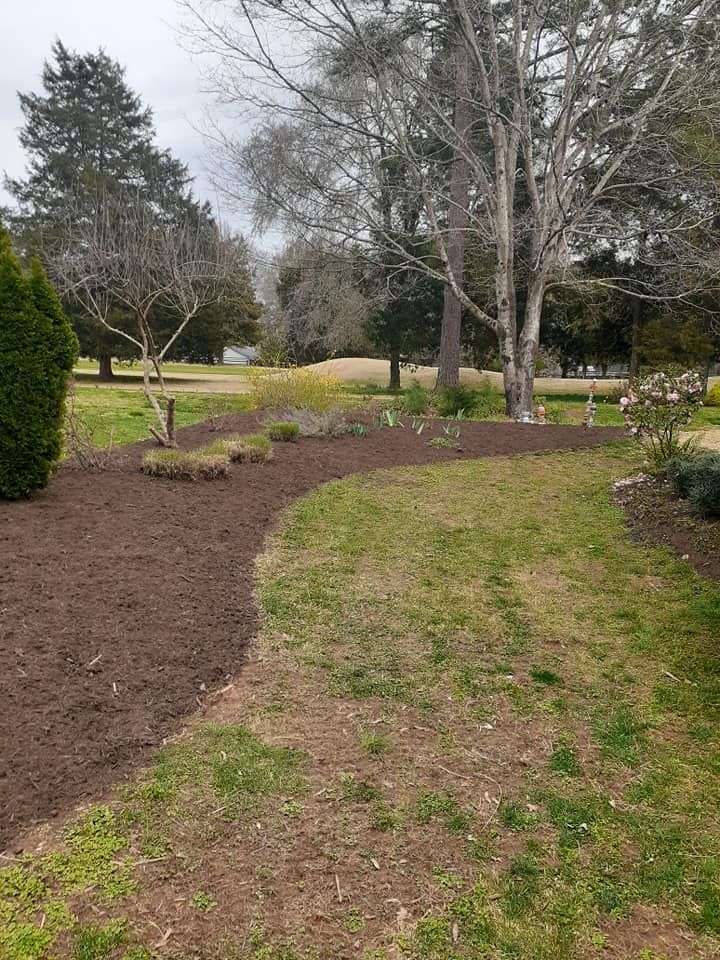 Enhance your landscape with our professional mulch installation service. We'll expertly lay high-quality mulch around trees and gardens to retain moisture, suppress weeds, and improve the overall aesthetics of your yard. for Oakhurst Landscaping and Tree Service in Charlotte, NC