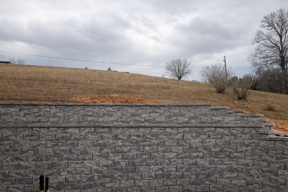 Enhance your outdoor space with our expert retaining wall construction, providing stability and aesthetic appeal to your landscape while preventing soil erosion and creating tiered garden possibilities for sustainable beauty. for East Premier Lawn Care in Kingston, TN