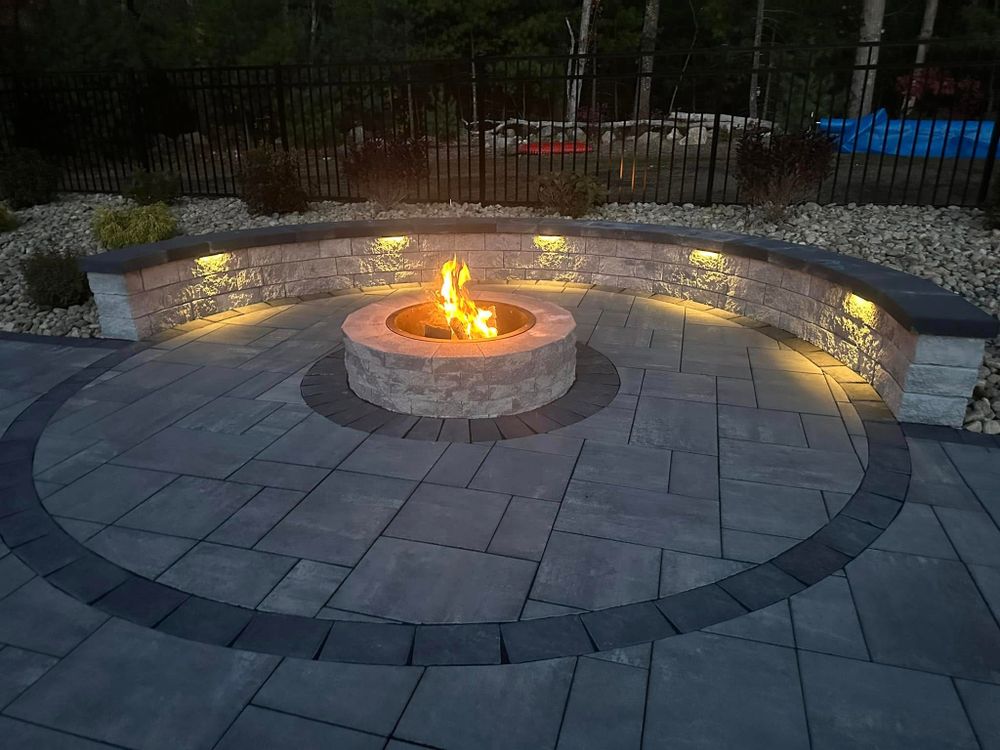 Enhance your outdoor experience with our custom fire pits, expertly designed and installed to complement your landscape, providing a cozy gathering spot for family and friends all year round. for Shawn's Landscaping in Mendon, MA