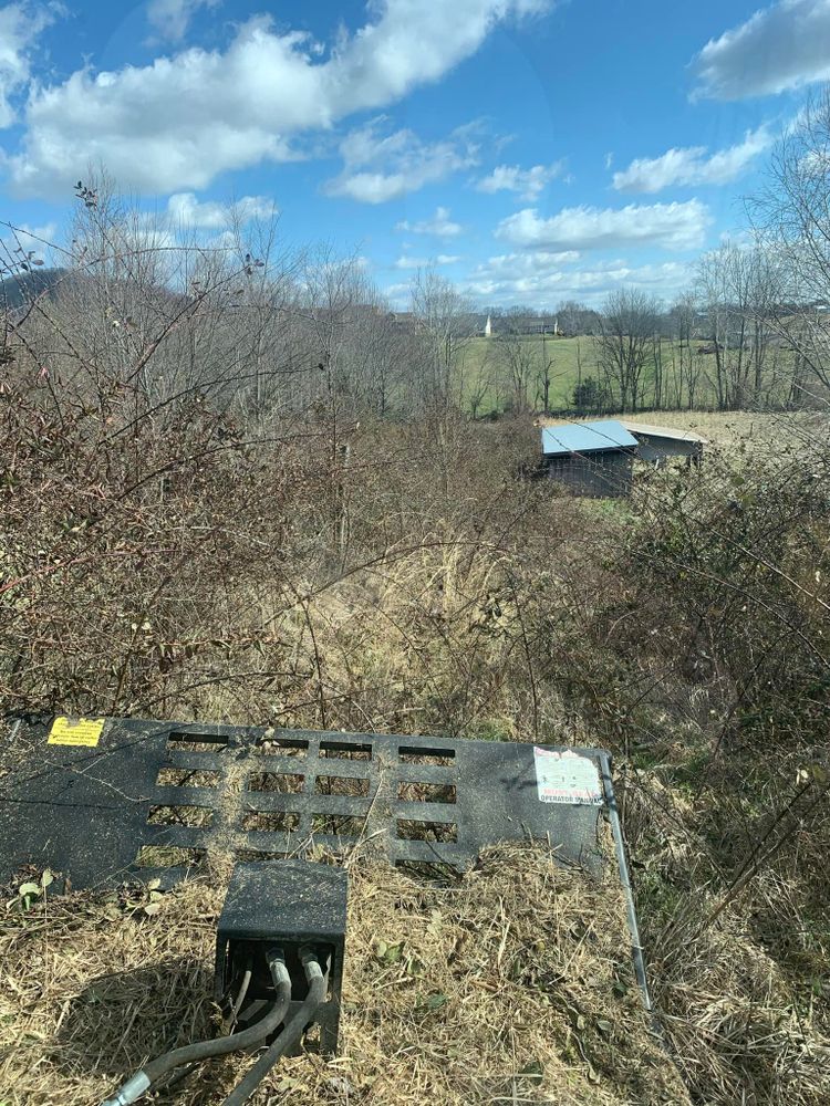 Our Bush Hogging service efficiently clears overgrown land, ensuring a clean and manageable property. Ideal for large areas, we provide precise and effective solutions, enhancing your landscape's health and appearance. for Wirt Construction in Greeneville, TN