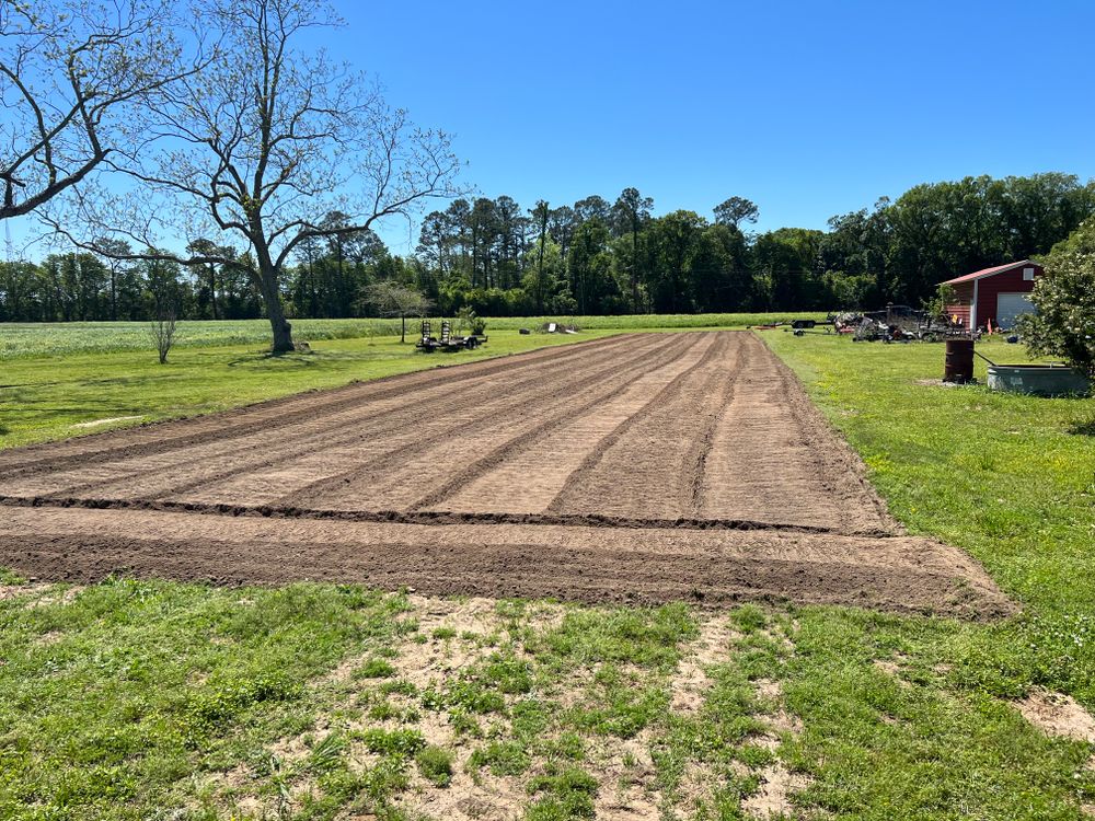 Our Raking & Tilling service enhances your garden's health by removing debris and aerating the soil, promoting better nutrient absorption and fostering a vibrant landscape for trees and plants. for Southern Venom Services in Daphne, AL