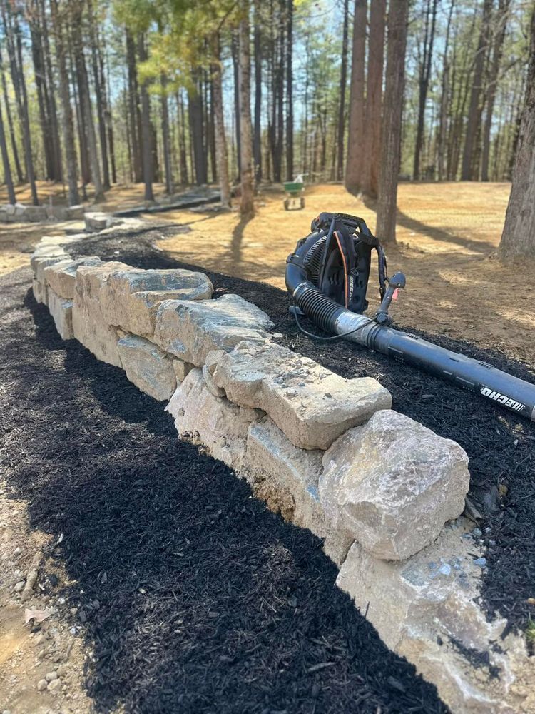 Our retaining wall construction service enhances your landscape by providing functional, durable structures that prevent soil erosion, manage drainage issues, and add aesthetic appeal to your property’s outdoor space. for The Lawn Guy in Saratoga Springs, NY