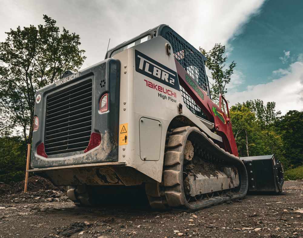 Our Skid Steer Work service offers efficient and versatile equipment for various tasks such as grading, trenching, and debris removal to help homeowners with their landscaping or construction needs. for Andy Naylor Excavation in Stowe, VT