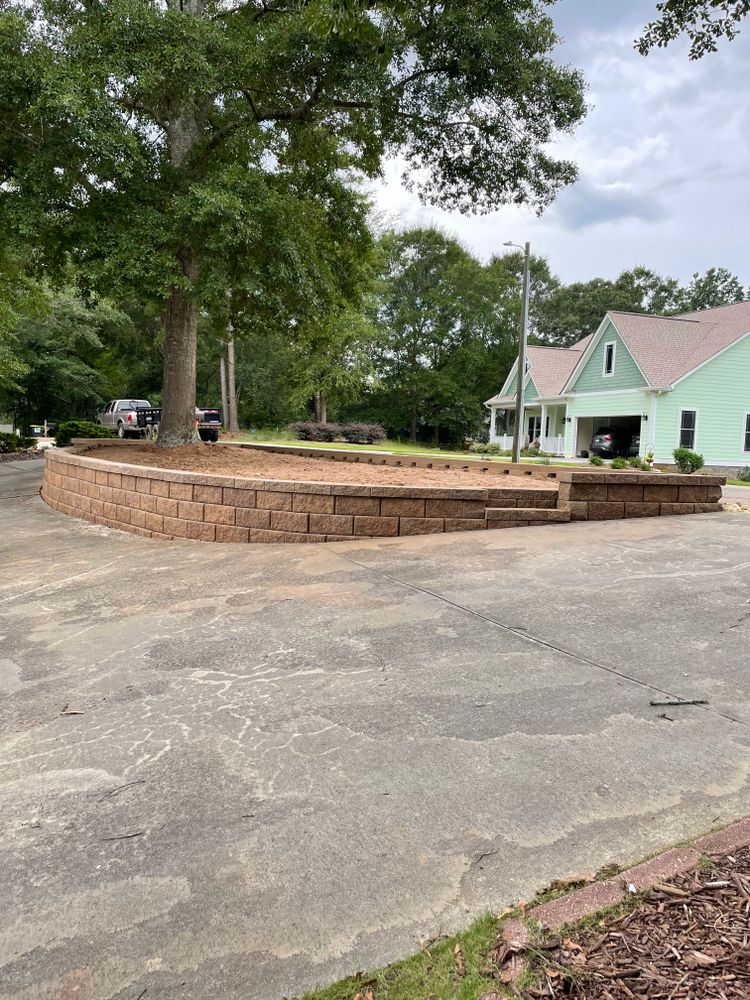 Enhance your outdoor living space with our natural stone hardscape service. From elegant patios to stunning retaining walls, we'll transform your backyard into a beautiful and functional oasis. for Peach State Landscaping in Hartwell, GA