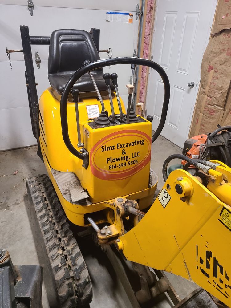 Our Skid Steer Work service offers efficient and versatile equipment for various tasks such as grading, trenching, and debris removal to help homeowners with their landscaping or construction needs. for Simz Excavating & Plowing LLC in Warren, PA