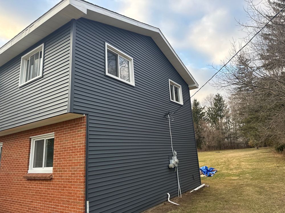 Our siding service offers durable and attractive options to protect your home from harsh weather conditions, while enhancing its overall curb appeal. Trust our experienced team for professional installation and quality results. for Walkers Quality Roofing  in Midland, MI