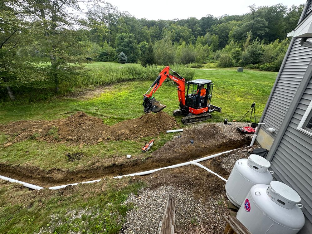 Our excavation meaning involves expertly digging and removing earth to install drainage systems that protect your property from water damage, ensuring a stable foundation for beautiful landscaping and hardscaping features. for NK Landscaping LLC in Dutchess County, NY