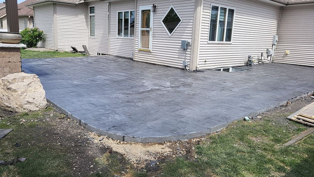 Transform your outdoor spaces with our Stamped Concrete Installation service, offering durable and visually stunning designs that mimic natural stone or tile, enhancing the beauty and value of your home effortlessly. for Golden Construction in West Fargo, ND