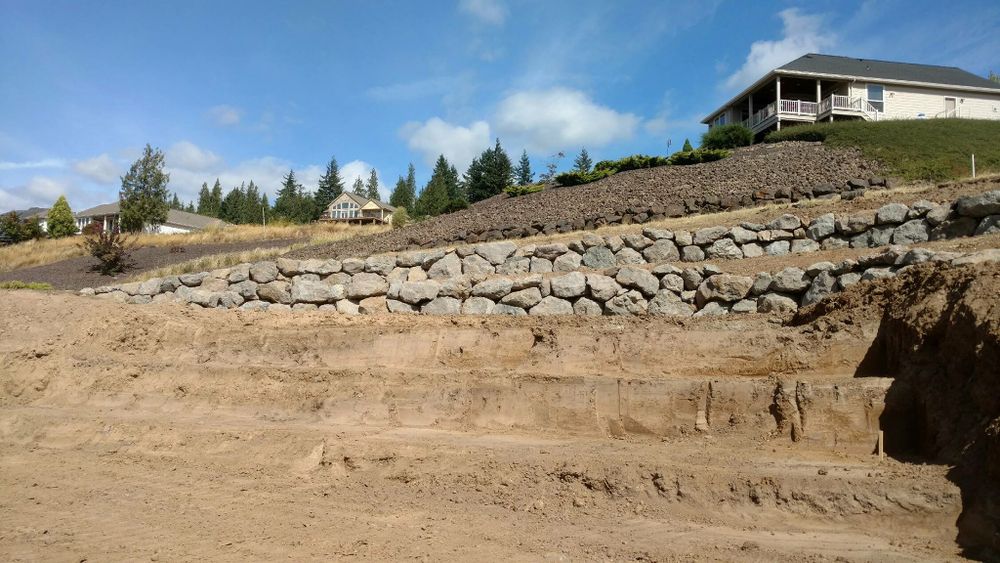 Transform your landscape with our expert Rock Walls service, offering durable, aesthetically pleasing solutions. We build retaining walls that enhance your property’s value and provide reliable erosion control for lasting beauty. for Buck & Sons Construction LLC in Woodland, WA