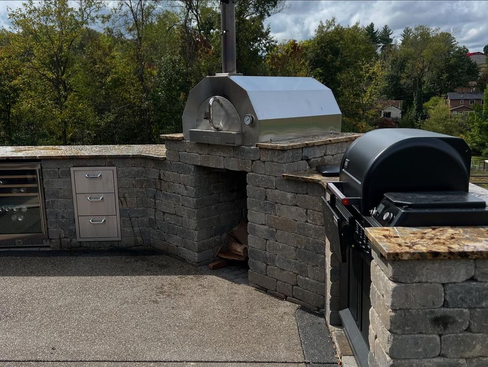 Enhance your backyard with our expert Outdoor Kitchen Construction, offering personalized designs and high-quality craftsmanship to create the perfect entertaining space that seamlessly integrates with your home's existing hardscape. for Henney’s Custom Hardscapes in Canonsburg, PA