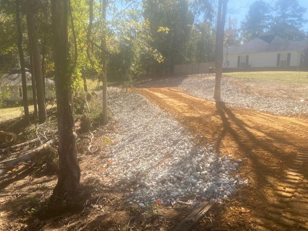 Our professional driveway construction service includes clearing and grading the land to create a solid foundation for a durable and aesthetically pleasing driveway that enhances the value of your property. for H&H Dirt Work in Corinth, MS