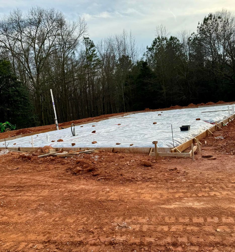 Discover what is concrete with our expert services, providing durable and versatile solutions for your home's construction needs. Our team ensures quality installations tailored to enhance and fortify your space. for Next Gen Pools & Construction in Royston, GA