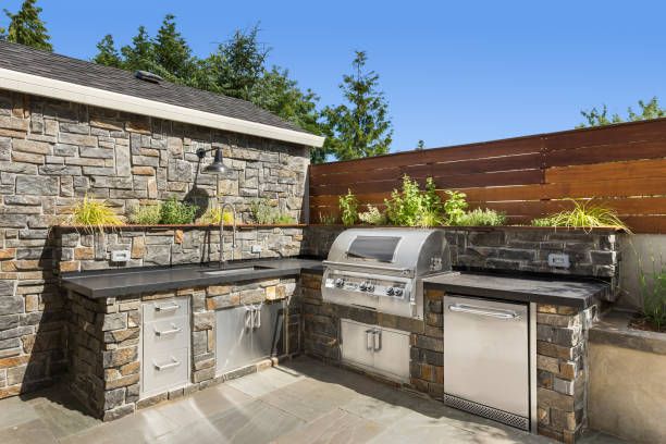Elevate your outdoor dining experience with our custom designed and expertly crafted outdoor kitchens. Our masonry team will transform your backyard into a functional and stylish entertaining space for all seasons. for Select Masonry & Roofing in Framingham, MA