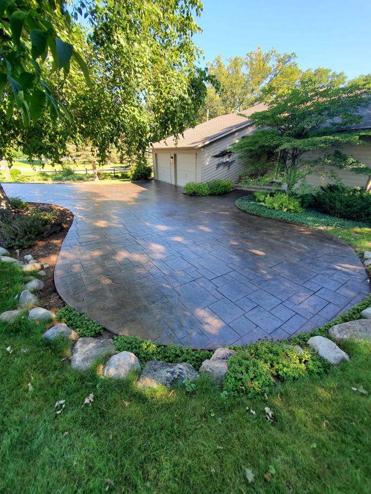 Enhance your home's curb appeal with our stained concrete service, offering vibrant colors and protection. Our expert driveway sealing ensures long-lasting durability against weathering, maintaining your driveway's pristine look for years. for Custom Concrete Coatings in Battle Lake, MN