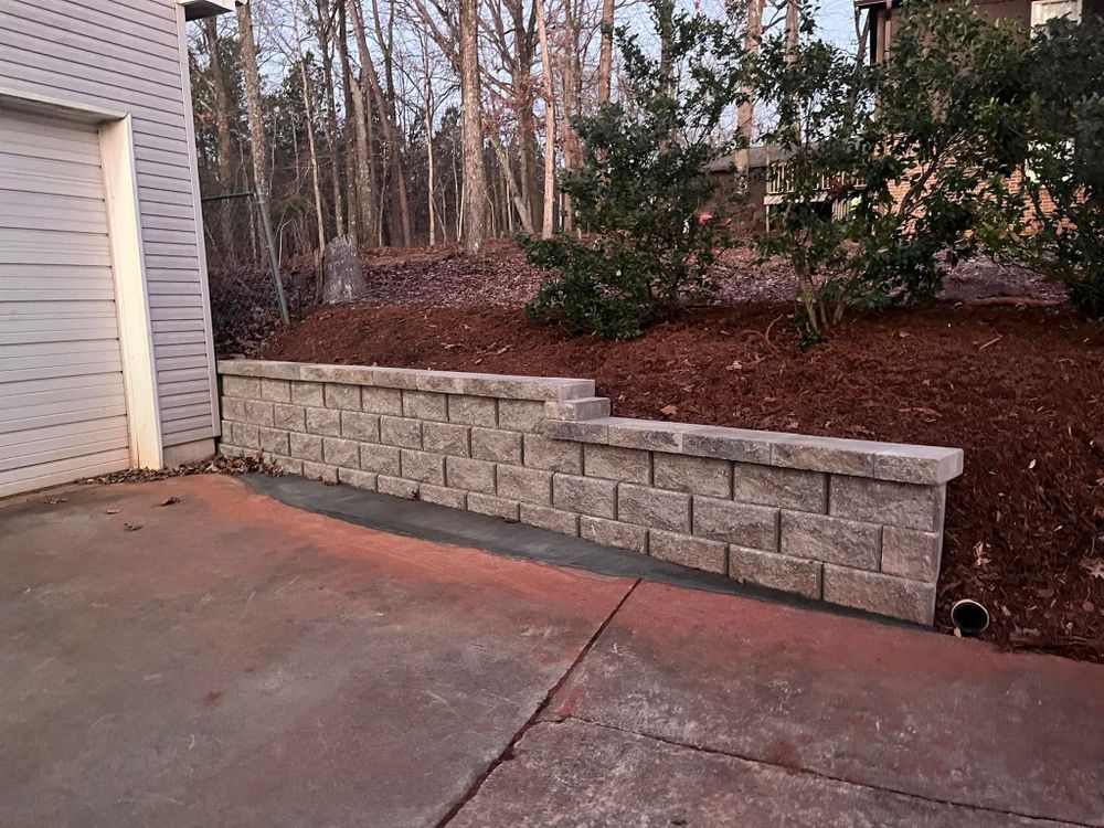 Our retaining wall construction service enhances your landscape by providing stability and preventing soil erosion, while adding visual appeal and functionality to your outdoor space tailored to your home's unique needs. for Cody’s Lawn & Landscape in Greer, SC