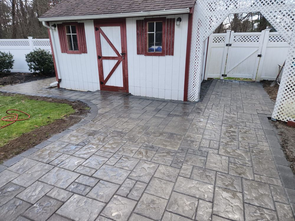 Enhance your home's curb appeal with our expert driveway construction services, seamlessly integrating patio design & construction to create a cohesive and inviting outdoor space that's both functional and aesthetically pleasing. for Graziano Empire in Billerica, MA
