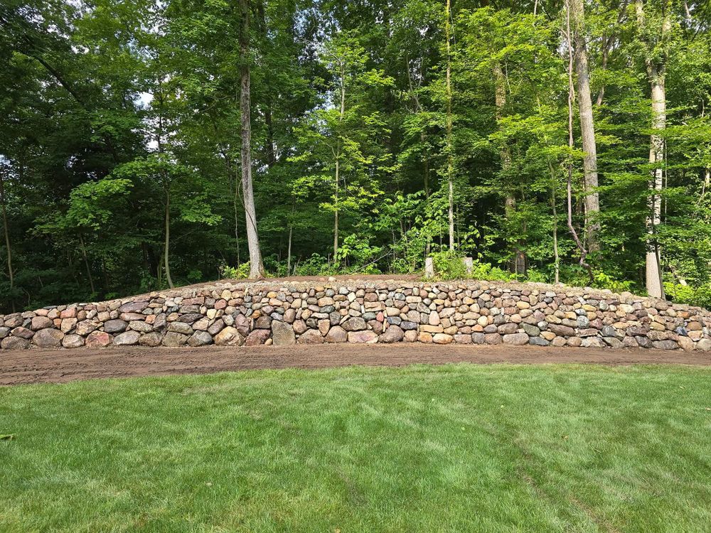 Enhance your lawn's health and vitality with our expert aeration service, which improves soil drainage, reduces compaction, boosts nutrient absorption, and promotes robust grass growth for a lush outdoor space. for Michiana Boulders Landscaping & Excavating in Union, MI