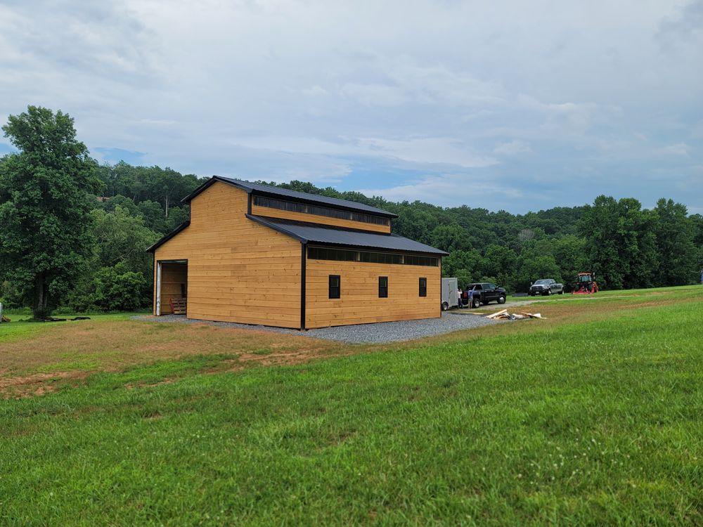 Transform your outdoor space with our steel truss pole barns & construction services, offering durable, customizable solutions that seamlessly integrate with your landscape for enhanced functionality and aesthetic appeal. for Platinum Outdoor Services LLC in Conover, NC