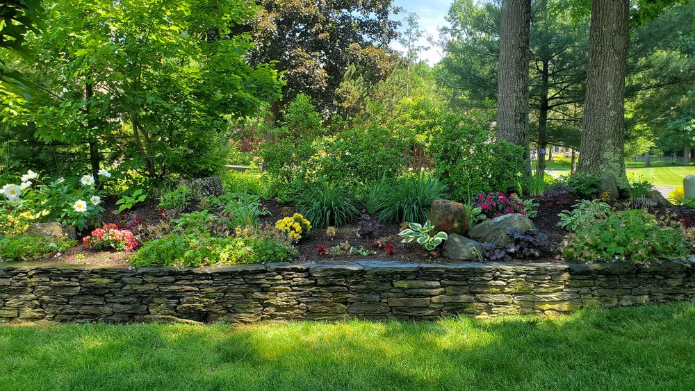 Enhance your property's appeal and functionality with our expert Retaining Wall Construction service, ensuring stability and beauty in your landscape while effectively managing soil erosion and supporting varied elevation levels. for Evolution Earthscapes, LLC in Ludlow, MA