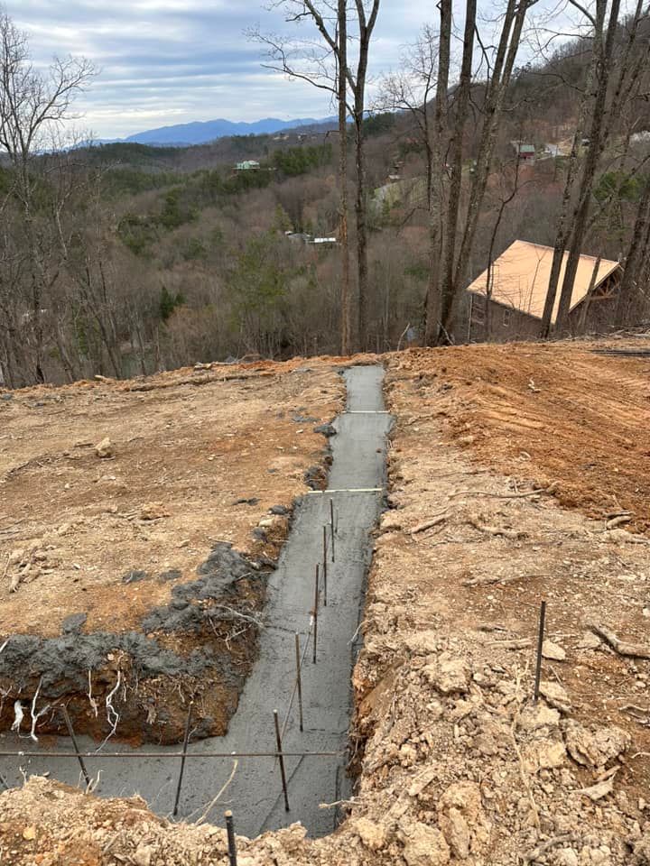 Our Footers service consists of expertly clearing and leveling land to create the foundation for your dream home, ensuring a solid base and optimal drainage for long-lasting construction. for Wilson Quality Construction  in New Tazewell, TN