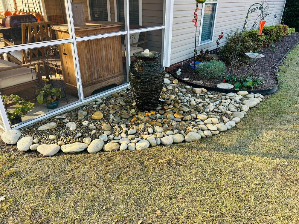 Transform your outdoor space with our River Rock service, offering durable and aesthetically pleasing stones perfect for pathways, garden beds, and water features to enhance your landscape's natural beauty. for Trophy Outdoor Solutions in Lexington, SC