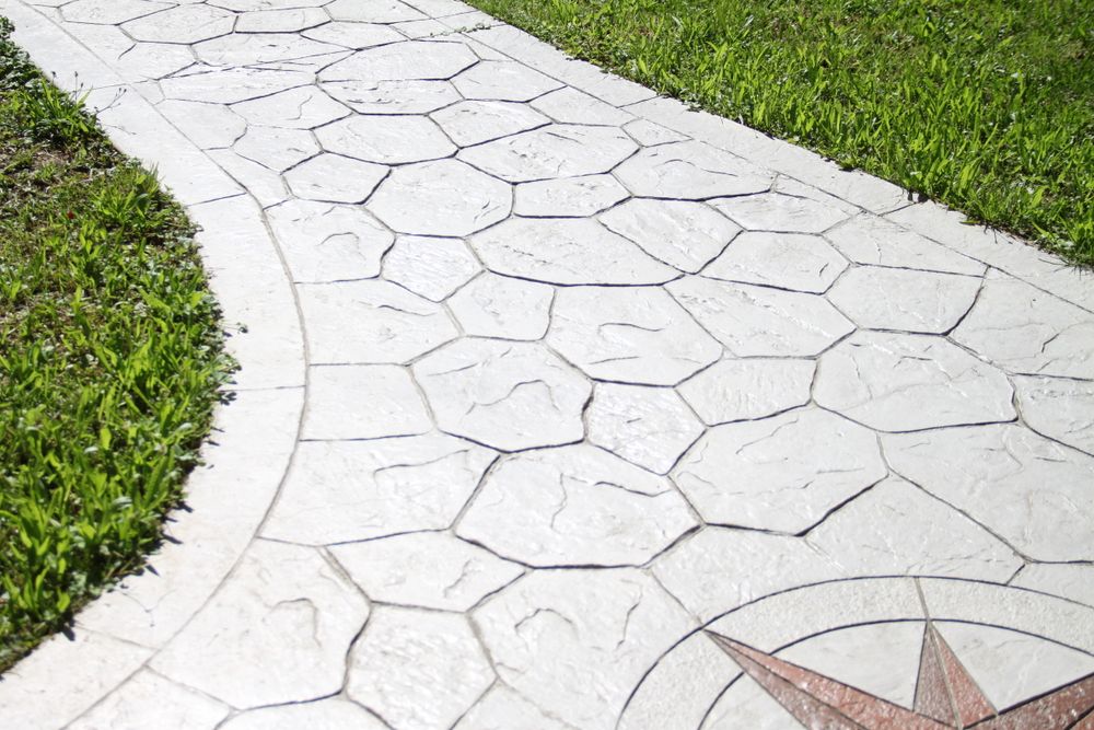 We offer stamped concrete installation to enhance your home's aesthetic appeal with customizable patterns and colors, providing a durable and cost-effective alternative to traditional paving options. for Stillwell Earthworks in Trussville, AL