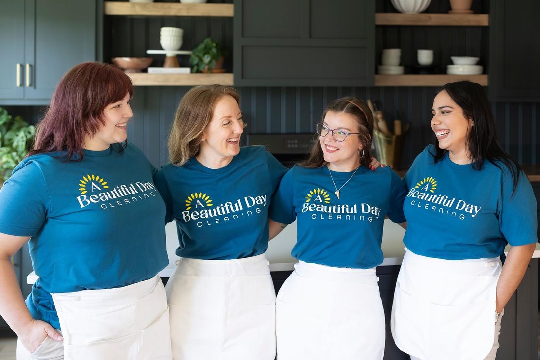 Four team members in aprons in a kitchen