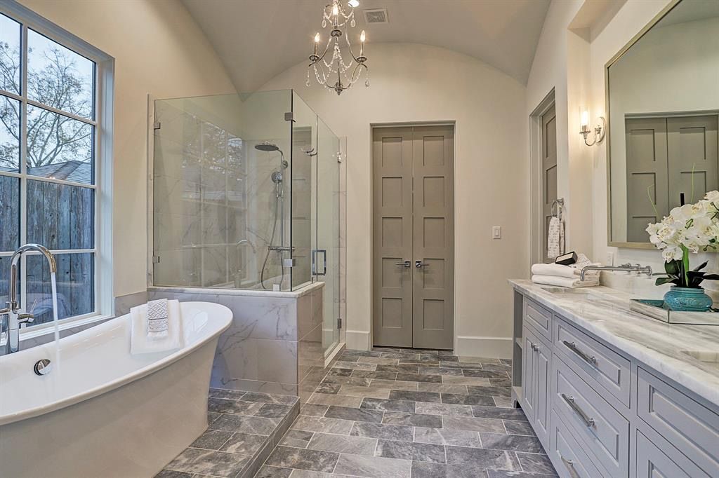 Remodeled bathroom with a freestanding tub and long double vanity